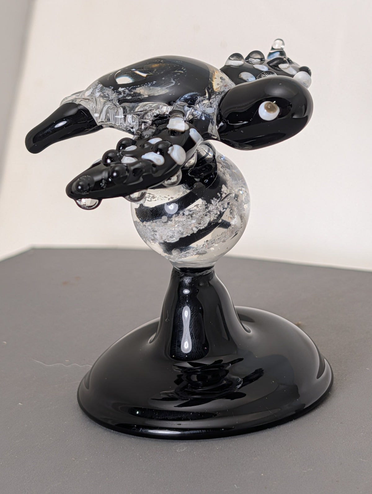 Black and clear turtle Legacy Goblet memorial sculpture with ashes in turtle and marble stem